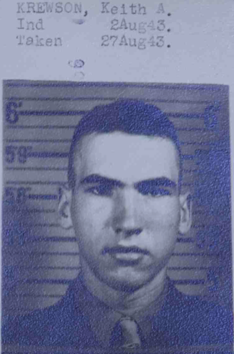 A black and white image of a young White man in a uniform.