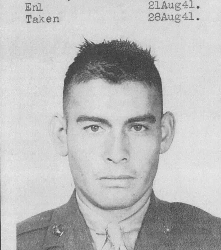 A black and white headshot of a young man in uniform.