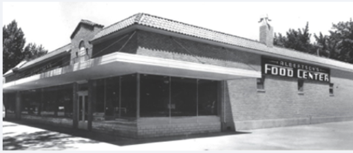 A black and white image of a single-story grocery store with “Albertsons Food Center” on the side.