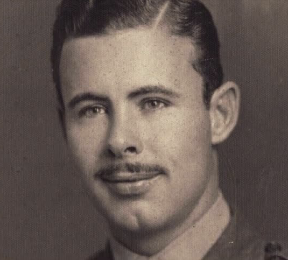 A black and white headshot of a young White man in uniform.