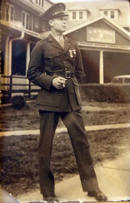 A black and white image of a young White man in uniform.