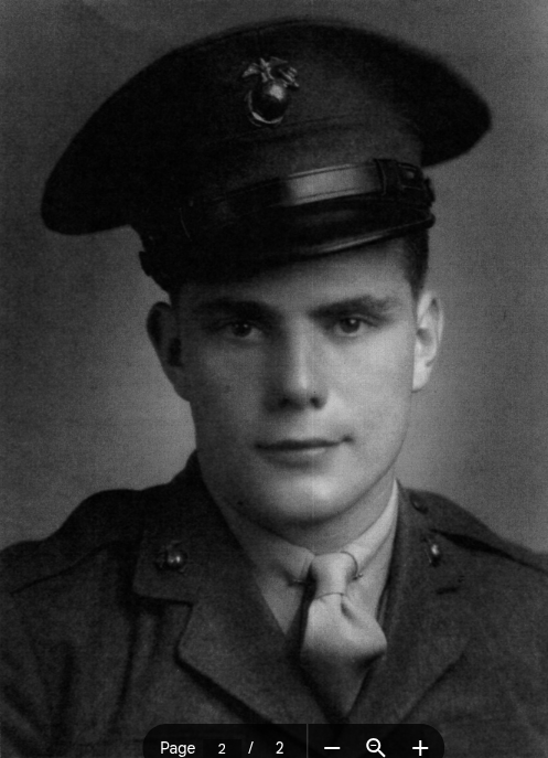 A young man in a Marine Corps uniform and hat.