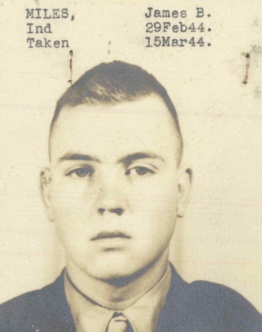 A black and white headshot photo of a young White man in a military uniform.