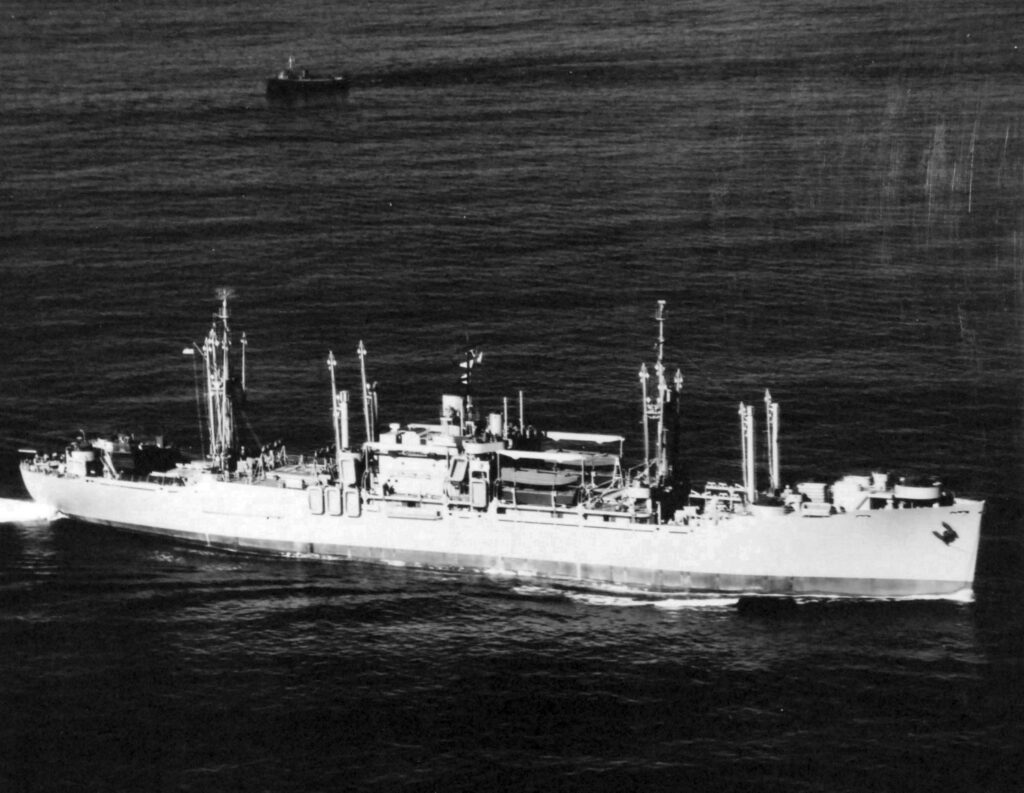 A black and white aerial image of a ship in the ocean.