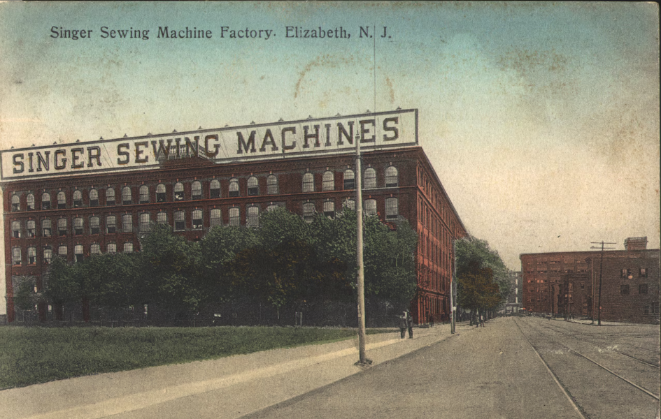 A color, drawn postcard of a four-story brick factory with sign on top reading “Singer Sewing Machines.”