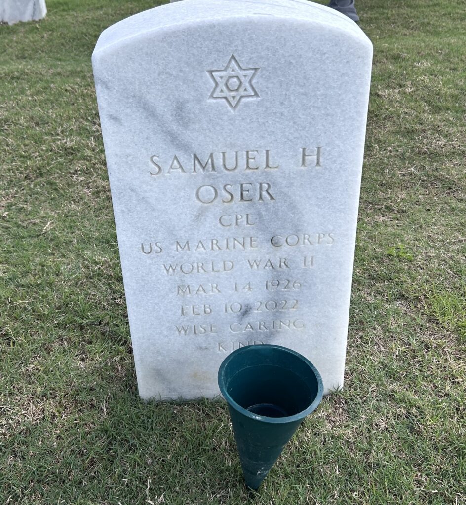 A white marble arched headstone is engraved with a Star of David and the words "Samuel H Oser CPL US Marine Corps World War II Mar 14 1926 Feb 10 2022 Wise Caring Kind."