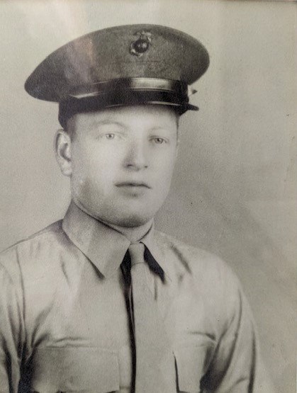 A black and white photo of a young White man in uniform.