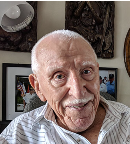 A older man in a dress shirt.