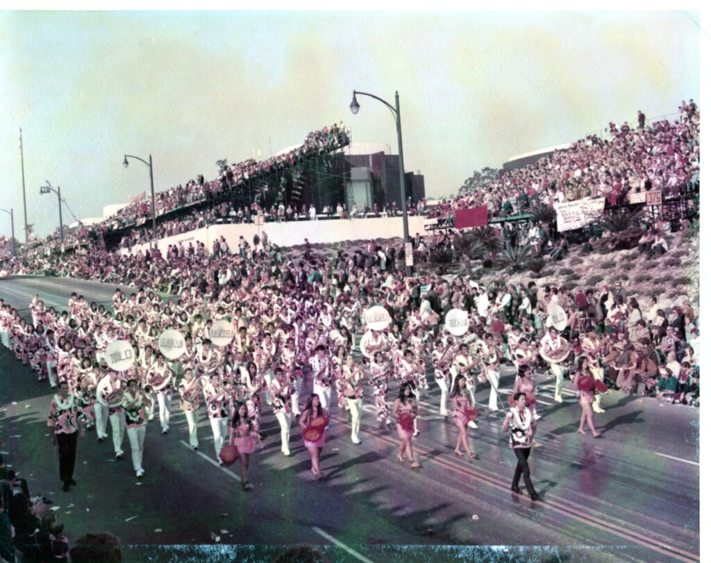 A color image of a large high school band on a parade route.