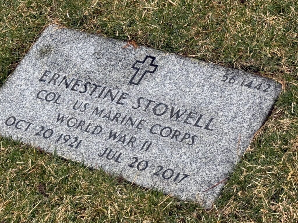 A color image of a headstone engraved with a cross and the words, “Ernestine Stowell COL US Marine Corps World War II Oct 20 1921 Jul 20 2017.”