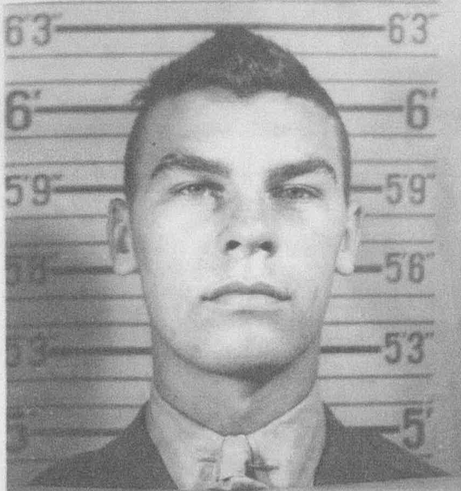 A black and white headshot image of a young White man in uniform.