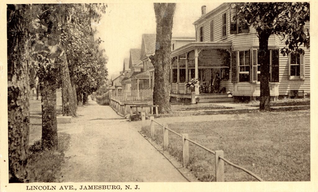 A sepia photograph looking down a sidewalk of a residential street. There are many similar two-story houses in a row. The street is tree-lined.