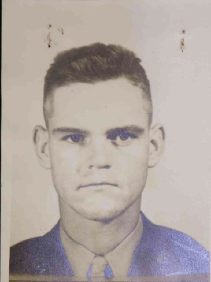 A sepia toned headshot of a young White man in uniform.