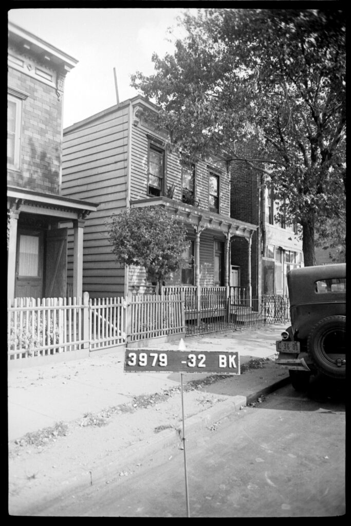 A black and white image of a two-story home. 