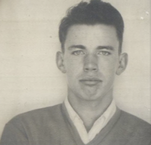 A black and white headshot of a young White man.