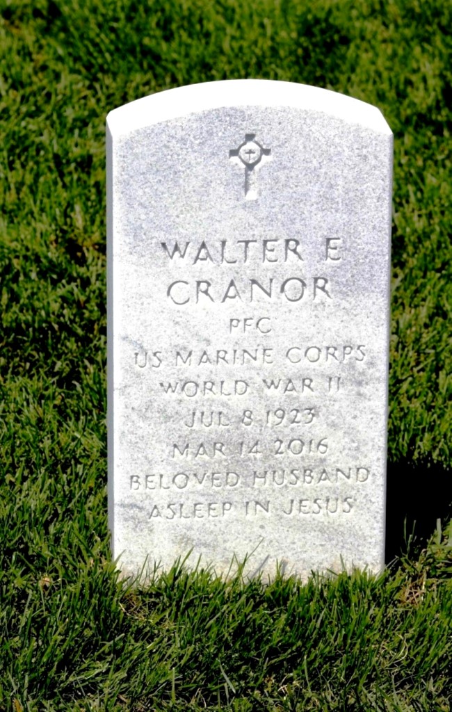 A color photo of a white marble headstone.