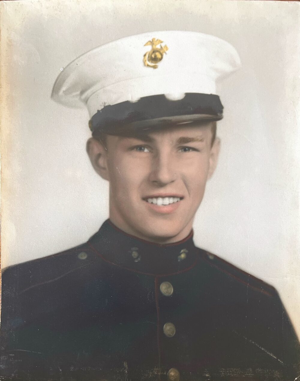 A colorized photograph headshot of a young White man in uniform.