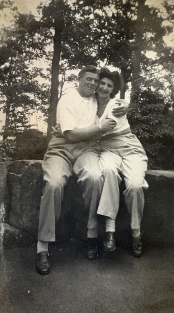 A black and white photo of a young couple embracing.