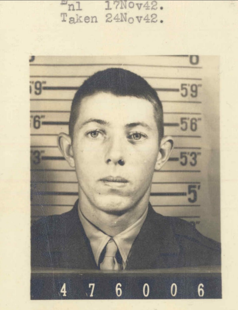 A black and white headshot of a young White man in uniform.