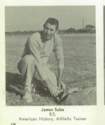 A black and white image of a young White man in athletic gear, kneeling on a field.