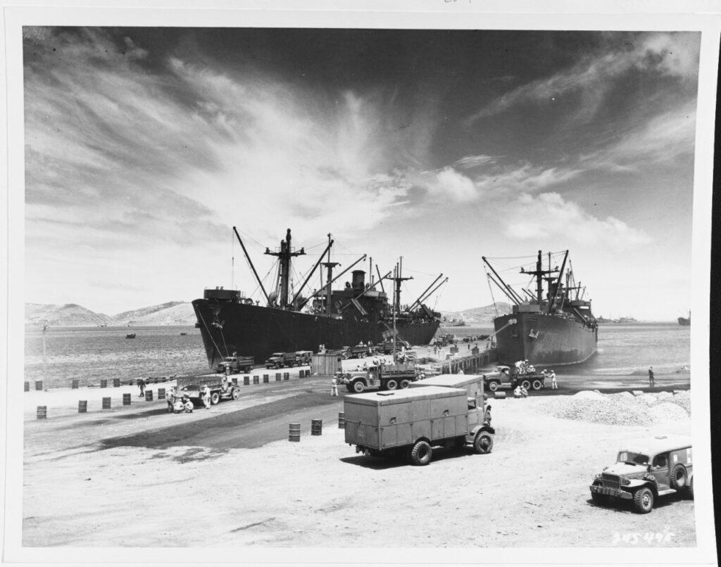 A black and white photograph of two large ships at port.