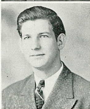 A black and white headshot of a young White man in a suit and tie.